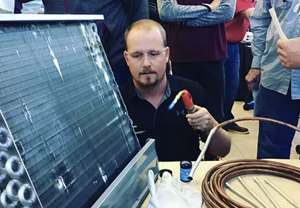 Bryan Orr demonstrating brazing on an HVAC coil