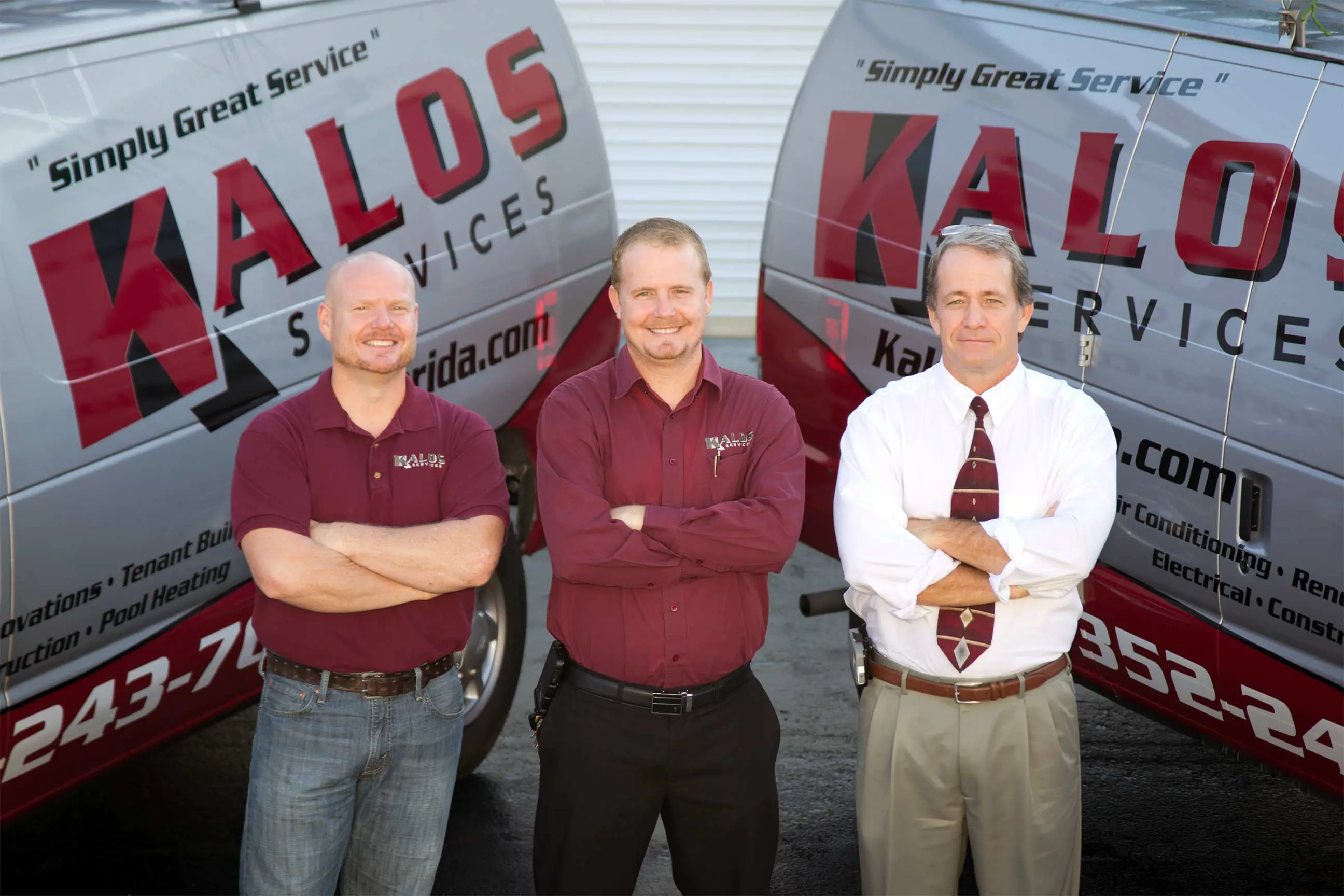 Bryan Orr and the Kalos Services team with company vans